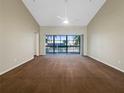 Bright bedroom with large windows and sliding glass doors at 6629 Pineview Ter # 5-201, Bradenton, FL 34203
