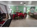 Bright dining area with a red tablecloth and four chairs at 1041 Porpoise Rd, Venice, FL 34293