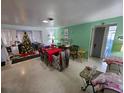 Dining room with red table and Christmas tree in the background at 1041 Porpoise Rd, Venice, FL 34293