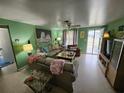 Cozy living room featuring neutral-toned furniture and a large tiger painting at 1041 Porpoise Rd, Venice, FL 34293