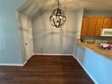Cozy dining area with modern light fixture, hardwood floors, and access to the kitchen at 12721 Sunland Ct, Tampa, FL 33625