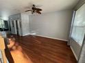Spacious living room with rich hardwood floors, neutral paint, and ample natural light at 12721 Sunland Ct, Tampa, FL 33625