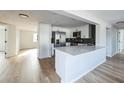 Modern kitchen with white cabinets, quartz countertops, and stainless steel appliances at 1490 Fundy Rd, Venice, FL 34293