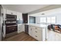 Modern kitchen with white cabinets, quartz countertops, and stainless steel appliances at 1490 Fundy Rd, Venice, FL 34293