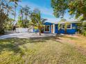 Cute blue house with a landscaped yard and palm trees at 4430 Huntington Ne St, St Petersburg, FL 33703