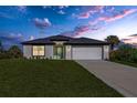 Single-story house with a two-car garage and landscaping at 4495 Eldron Ave, North Port, FL 34286