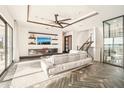 Spacious living room with herringbone floors, large TV, and wine cellar at 7801 9Th S Ave, St Petersburg, FL 33707