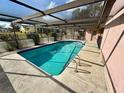 Relaxing kidney-shaped pool with screened enclosure at 12010 Villa Rd, Spring Hill, FL 34609