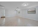 Spacious living area with tile floors and neutral walls at 4135 Bell Ave, Sarasota, FL 34231