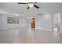 Bright and spacious living area with tile floors and access to kitchen at 4135 Bell Ave, Sarasota, FL 34231