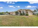 House exterior showcasing a large front yard and a spacious driveway at 2454 Yalta Ter, North Port, FL 34286