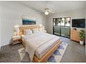 Spacious main bedroom with wood platform bed and balcony access at 2364 Hanover Dr, Dunedin, FL 34698