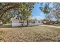 Charming ranch house with mature trees and a spacious yard at 4404 Terry Loop, New Port Richey, FL 34652