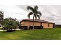 Side view of house showcasing stucco exterior and landscaping at 8044 Stirling Falls Cir, Sarasota, FL 34243