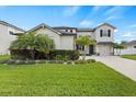 Two-story house with a landscaped yard and driveway at 12211 Streambed Dr, Riverview, FL 33579