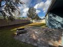 Spacious backyard with paver patio and fire pit at 1570 Fox Grape Loop, Lutz, FL 33558