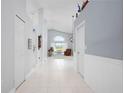 Bright and spacious entryway with tile flooring and views of the living area at 5923 Sandstone Ave, Sarasota, FL 34243
