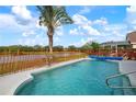 Inviting swimming pool with a tranquil view of a pond and lush greenery at 5923 Sandstone Ave, Sarasota, FL 34243