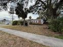 Ranch-style home with palm trees and a spacious yard at 6002 Town N Country Blvd, Tampa, FL 33615