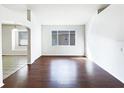 Spacious living room featuring hardwood floors and lots of natural light at 34434 Windknob Ct, Wesley Chapel, FL 33545