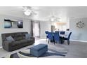 Comfortable living room featuring a sofa, dining area, and neutral decor at 15427 Winter Breeze Ln, Wimauma, FL 33598