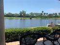 Waterfront view from patio, featuring two rocking chairs at 1322 Pelican Creek Xing # B, St Petersburg, FL 33707