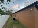 Back exterior view of the house with AC unit and a white vinyl fence at 2267 50Th Street E Cir, Palmetto, FL 34221