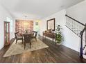 Bright dining room with hardwood floors and a large decorative wall at 7480 Aguila Dr, Sarasota, FL 34240
