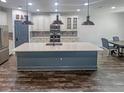 Spacious kitchen featuring a large center island, stainless appliances, and pendant lighting at 7480 Aguila Dr, Sarasota, FL 34240