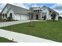 Beautiful single-story home with a three-car garage and a well-maintained lawn at 14036 Prairie Hill Rd, Dade City, FL 33525