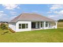 Rear exterior showing covered porch and manicured lawn at 14036 Prairie Hill Rd, Dade City, FL 33525