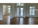 Bright foyer featuring hardwood floors, elegant double doors, and high ceilings at 14036 Prairie Hill Rd, Dade City, FL 33525