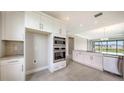 Bright kitchen featuring stainless appliances, white cabinetry, granite countertops, and open floor plan at 14370 Hammock Oak St, Parrish, FL 34219