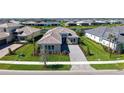 An aerial view of a home with a gray brick driveway, well-manicured landscaping, and a stunning tile roof at 4621 Mondrian Ct, Sarasota, FL 34240