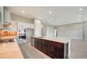 The kitchen features stainless steel appliances, a tiled backsplash, and a center island with a sink at 4621 Mondrian Ct, Sarasota, FL 34240