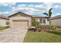Charming single-Gathering home features a two-car garage and well-manicured landscaping with a brick driveway at 466 Sun Chaser Dr, Nokomis, FL 34275