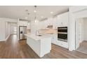Modern kitchen with stainless steel appliances, and a large center island at 466 Sun Chaser Dr, Nokomis, FL 34275