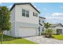 Attractive two-story home with brick paver driveway, two-car garage, and neutral color palette at 474 Sun Chaser Dr, Nokomis, FL 34275