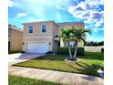 Two-story home featuring a palm tree in the front yard, a white garage door, and a tidy lawn at 109 Tierra Verde Way, Bradenton, FL 34212