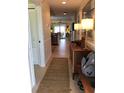 Inviting entryway featuring tile flooring, a wooden console table with lamps, and a view into the living spaces at 3233 Purple Martin Dr # 121, Punta Gorda, FL 33950