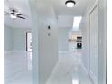 Bright hallway with tile floors, skylight, and neutral walls, connecting the living spaces at 1147 Yachtsman Ln, Punta Gorda, FL 33983