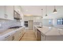 Bright, modern kitchen with stainless steel appliances, stone countertops, and ample cabinet space at 14451 Coastal Woodland Ln, Parrish, FL 34219