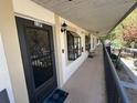 Exterior view of condo unit 13F, with a black door, overhead lighting, and a covered walkway at 11511 113Th St # 13F, Seminole, FL 33778