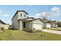 Lovely two-story home with a manicured lawn and an attached two-car garage at 2318 E Newsome Rd, Plant City, FL 33565