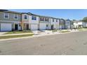 Street view of modern townhomes with sidewalks and well-maintained landscaping at 11873 Sylvia St, Dade City, FL 33525