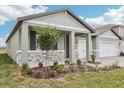 Charming one-story home featuring stone accents and a well-manicured front yard with lush plants at 1832 Draughton Dr, Zephyrhills, FL 33541