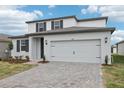 Charming two-story home with neutral paint, complemented by a two-car garage and landscaped yard at 1867 Draughton Dr, Zephyrhills, FL 33541