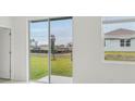 Bright interior view highlighting a large sliding glass door overlooking the backyard at 1868 Brekey Way, Zephyrhills, FL 33541