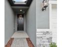 A welcoming entryway features stylish stone accents and modern lighting at 1886 Draughton Dr, Zephyrhills, FL 33541