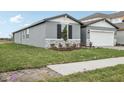 Charming single-story home with stone accents and a well-manicured lawn at 1886 Draughton Dr, Zephyrhills, FL 33541